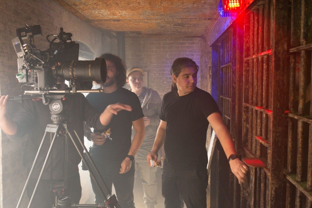 DreamPlay BTS GRIND_Li 9_WEB Director discussing a jail door slamming shut