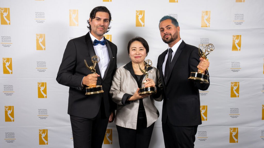 Producer: Igor Alves, Conductor: Xian Zhang, Director: Yuri Alves holding Emmy
