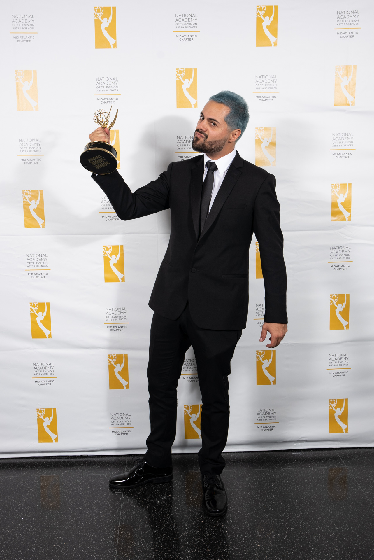 Director Yuri Alves holding Emmy Statuette