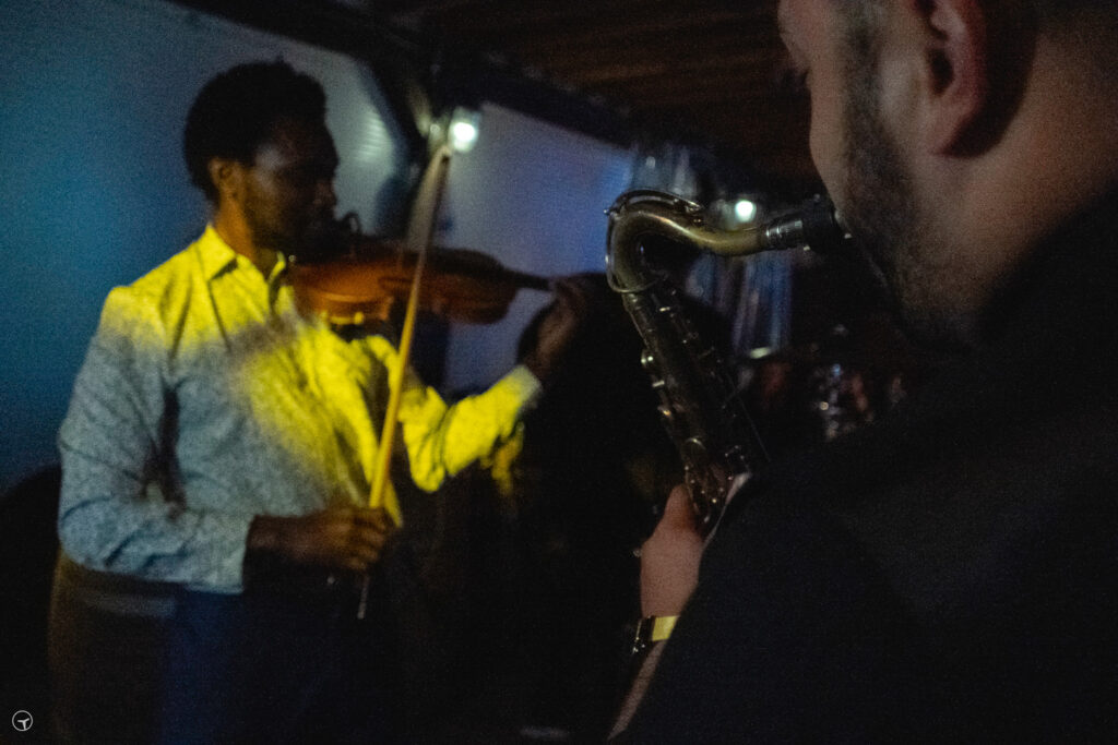 violinist J Read and saxophonist Raphael Sax performing at EMERGE GRIND screening afterparty
