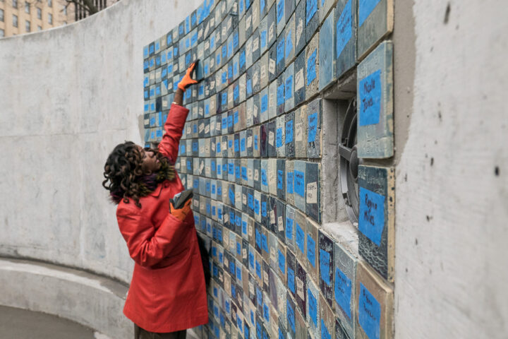 ADEBUNMI GBADEBO placing a tile on the wall
