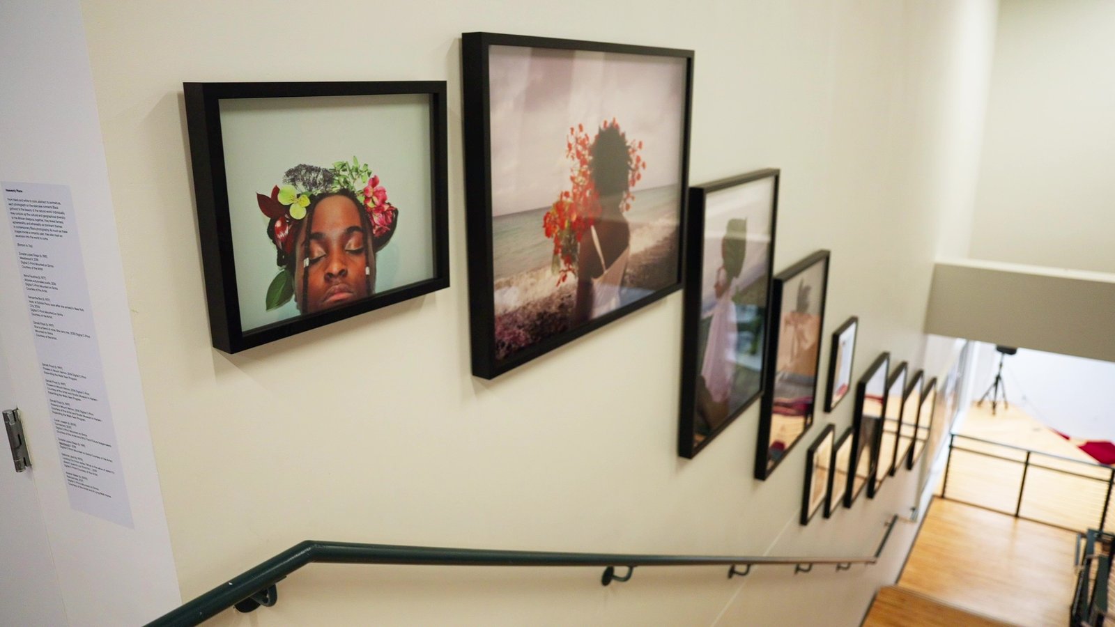 Staircase of Express Newark filled with photos