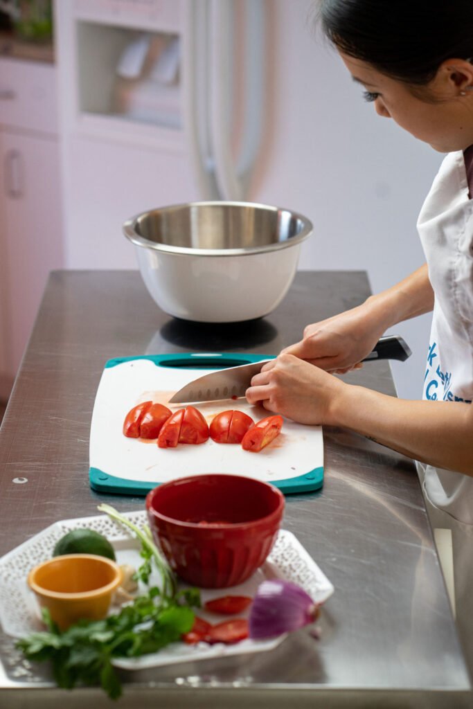 Emily Ho doing a cooking demonstration - Photo by Sofia Tome