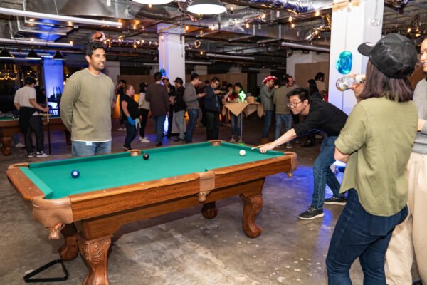 Audible holiday party people playing pool