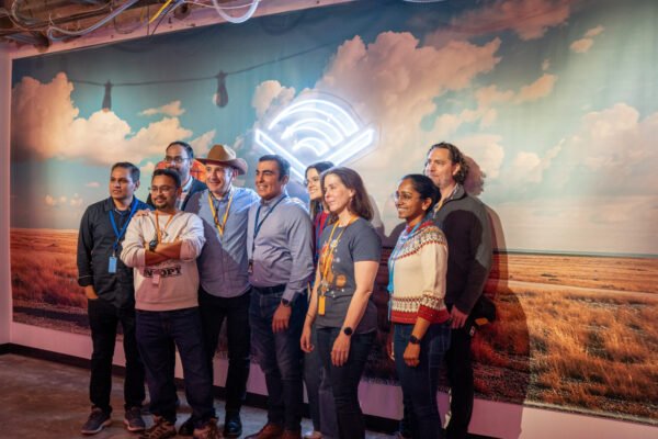 Group photo near audible western backdrop