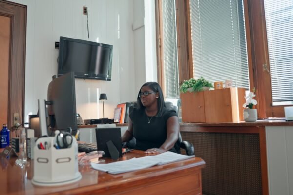 tiffany sitting down at her desk