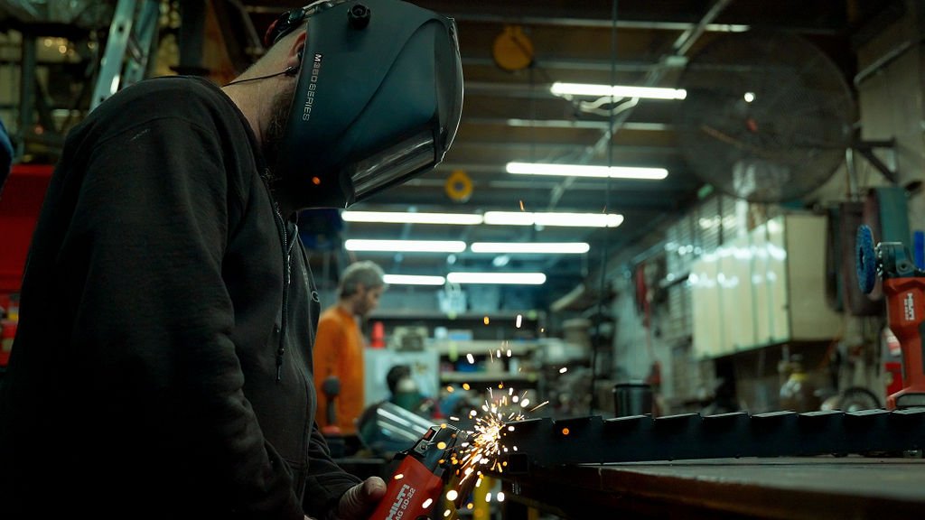 Fabricator of sculpture sanding metal