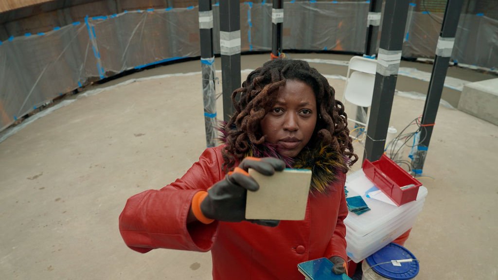 Adebunmi placing tile on Harriet Tubman monument